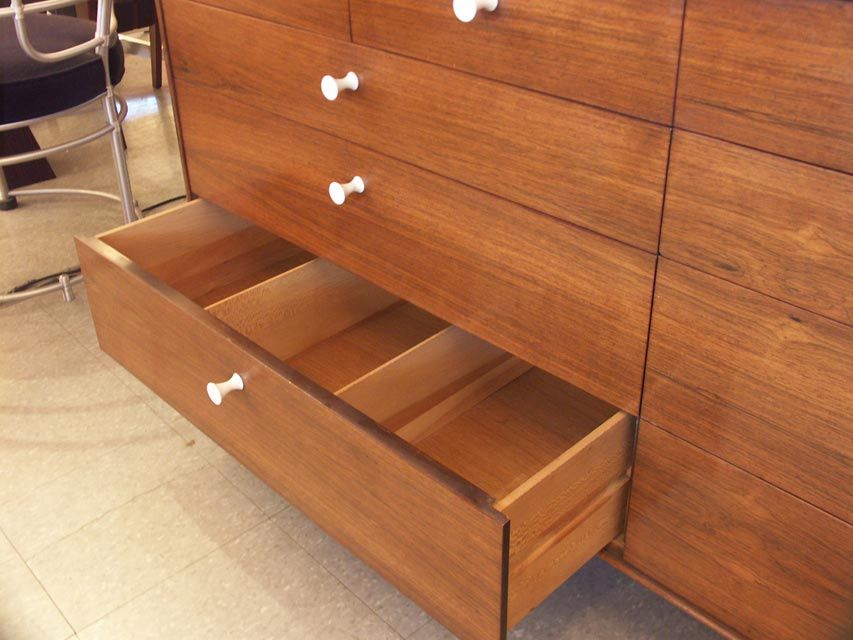 Large rosewood chest by Nelson for Herman Miller. 4 narrow drawers sit above six large, all with porcelain pulls. The lower drawers feature dividers, and one top drawer has a foil label.