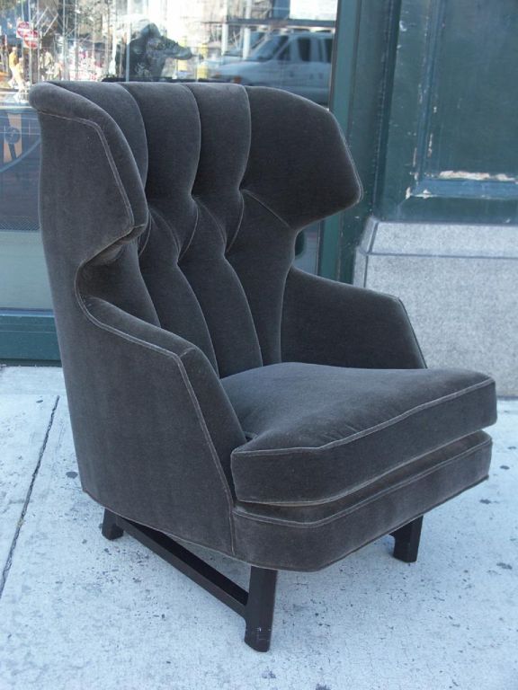 Magnificent lounge chair and matching ottoman by Wormely for Dunbar. A highly angular frame, expertly upholstered, the tufting forming deep channels in the seat back. True comfort with a very classy look, perfect for the den or library (fireplace,