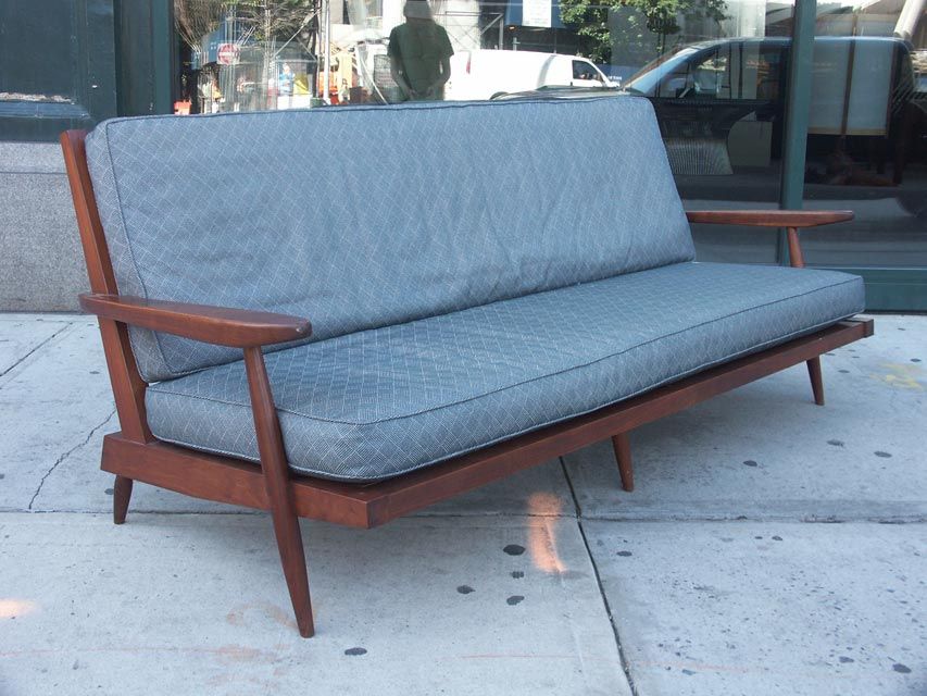 Large 3 seat sofa by Nakashima, in solid walnut. Attractive slat back design, perfect for floating in the room. Carved arms and a deep seat for serious lounging. Seat and back cushions are included and would welcome reupholstery.
