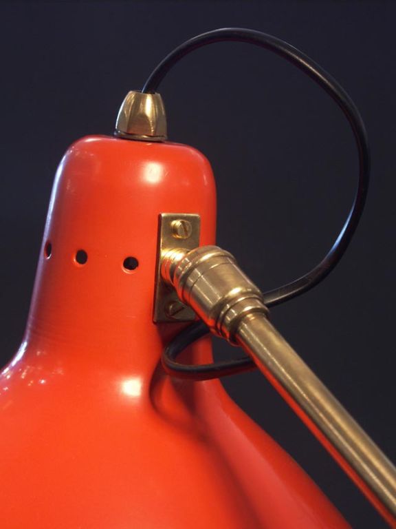 Sharp and attractive desk lamp by Disderot, France 1950's. Following in the footsteps of Serge Mouille, it features a fully adjustable shade with the nipple styling allowing the bulb to seat as far into the reflector as possible. Brilliant orange