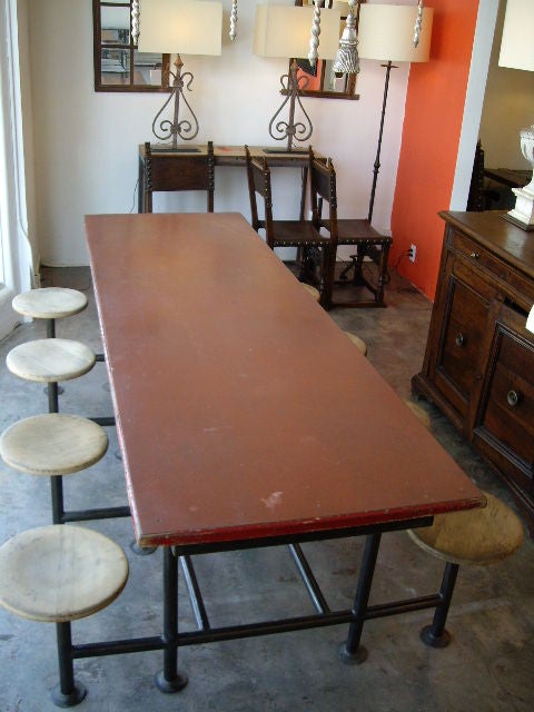 Red Iron Table With Eight Attached Stools