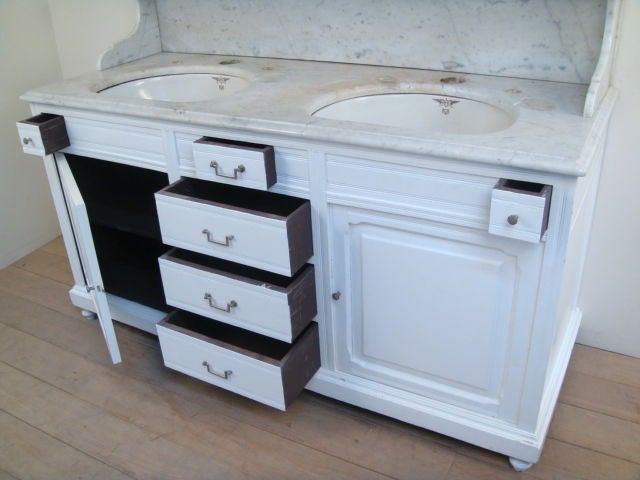 Sleek white Belgian bathroom vanity with marble top and inset sink.<br />
Shelf height is 11 1/2