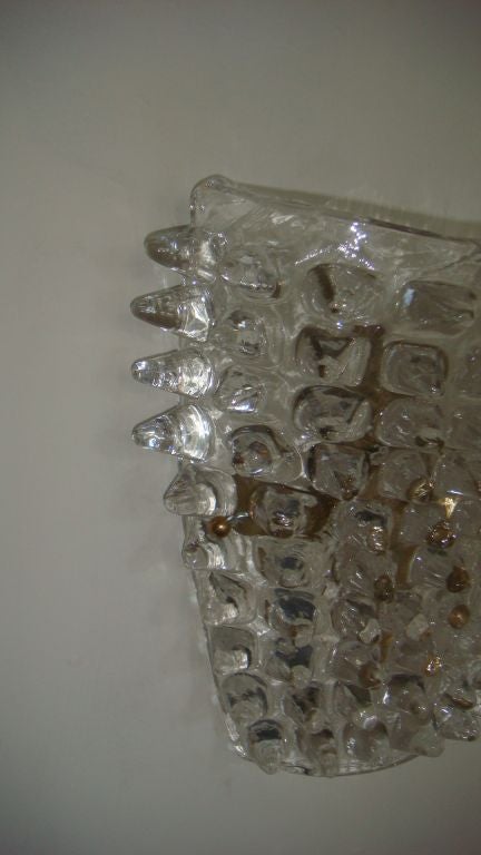 Pair of interesting glass wall sconces with brass fittings.