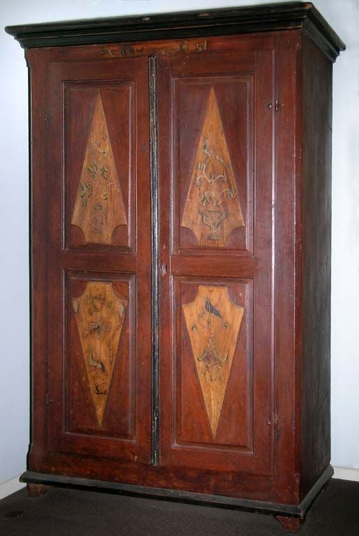 Well preserved wedding armoire in original paint. The four raised door panels, each display a charming Folk Art painting of a different bird (Rooster, peacock, stork and Crow), along with symbolic 