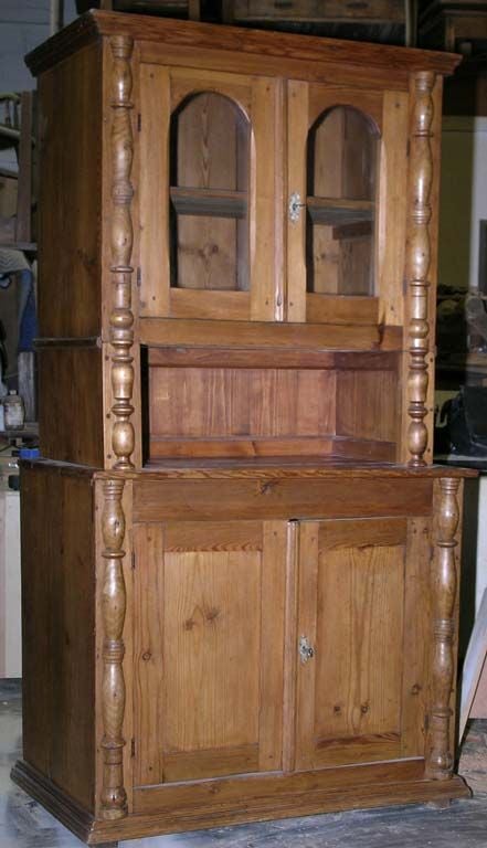 Hutch with 2 doors below, 2 above with glass panels and cubby hole in the middle. Turned columns in birch down the sides. Very well made piece, dove-tailed top and bottom. Original locks work. Comes apart in 3 pieces.<br />
<br />
More pictures
