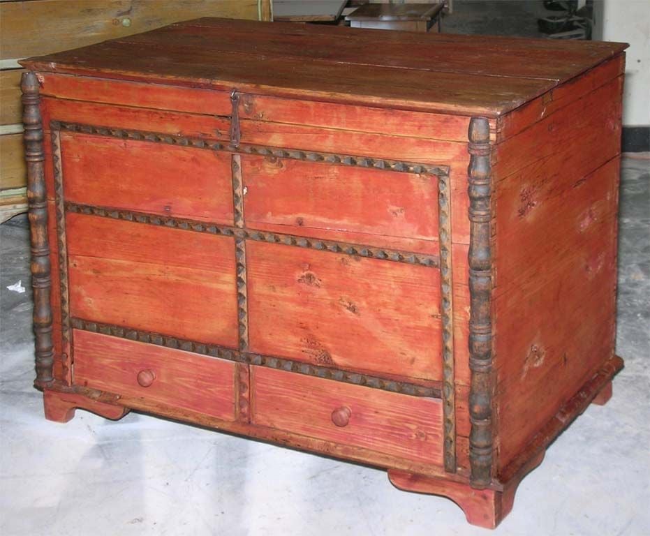 Charming country chest in red paint with turned columns and carved mouldings. Has interior candle box and two large drawers below.