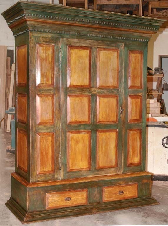This massive armoire was handmade in our Latvian workshop entirely from antique elements and using traditional joinery techniques. It features 18 floating panels, two drawers and adjustable interior shelving. Lots of storage space! Lock and key