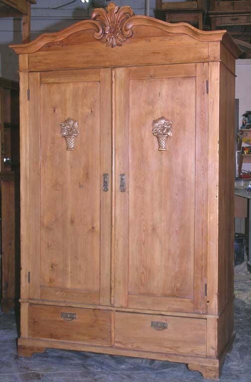 Armoire or wardrobe with two drawers and nice carvings. Very well-built with dovetail joints all around. Lock and key still work. Has rod for hanging clothes but we can modify an interior for any needs.

Interior depth is 19.5