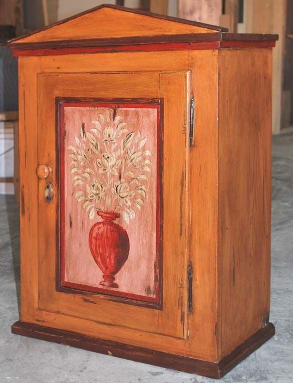 Wall hanging cabinet with hand-painted floral decorations and carved bone escutcheon. Great medicine cabinet! 

Interior depth is 8