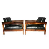 Pair of large rosewood frame and black leather lounge chairs