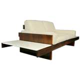 Rosewood and leather settee, attached floating marble tables