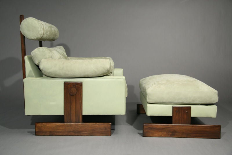 A unique Chair and Ottoman made from solid Walnut and upholstered in Mint Green leather and suede. Includes bolsters on the arms.

Seat depth 20.5