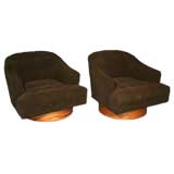 Pair of tufted brown swivel chairs with rosewood bases