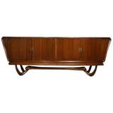 Exotic curved wood base and scalloped front buffet by John Graz