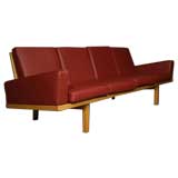 Oak frame sofa with red leather upholstery