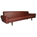 Plum leather and rosewood sofa