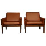 Pair of rosewood and brick leather arm chairs by Hans Wegner