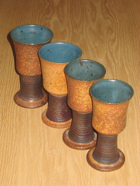 Set of four speckled brown glazed stoneware goblets with dark stems and bright blue inside by Victoria Littlejohn.