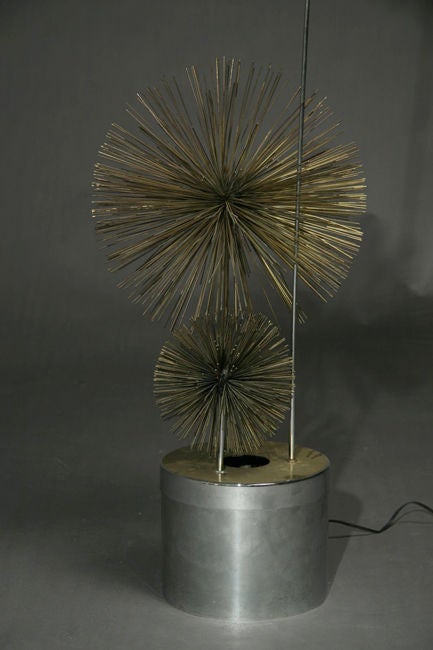 A decorative brass sea urchin floor lamp with a cylindrical base by Curtis Jere.
