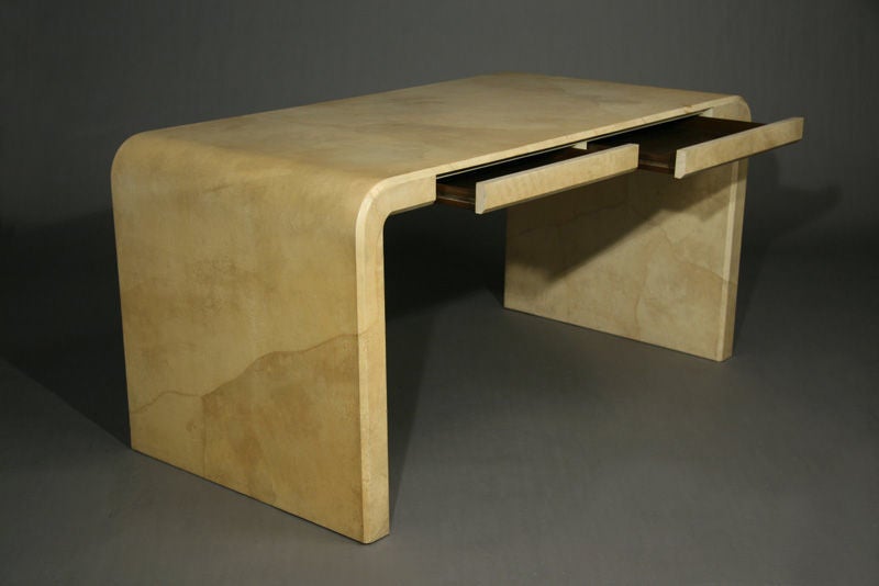 A lovely waterfall desk made of lacquered goatskin with two drawers designed by Karl Springer.