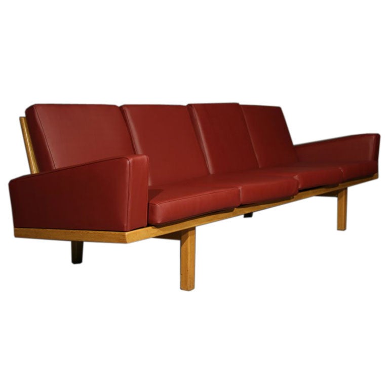 Oak frame sofa with red leather upholstery 