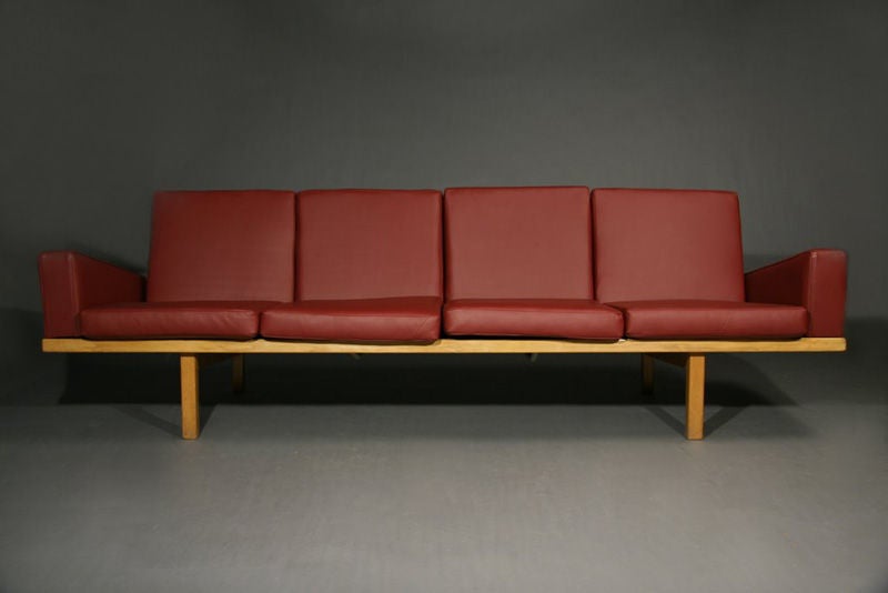 A red leather sofa with oak frame and slatted back from Denmark in the style of Hans Wegner.

Many pieces are stored in our warehouse, so please click on CONTACT DEALER under our logo below to find out if the pieces you are interested in seeing