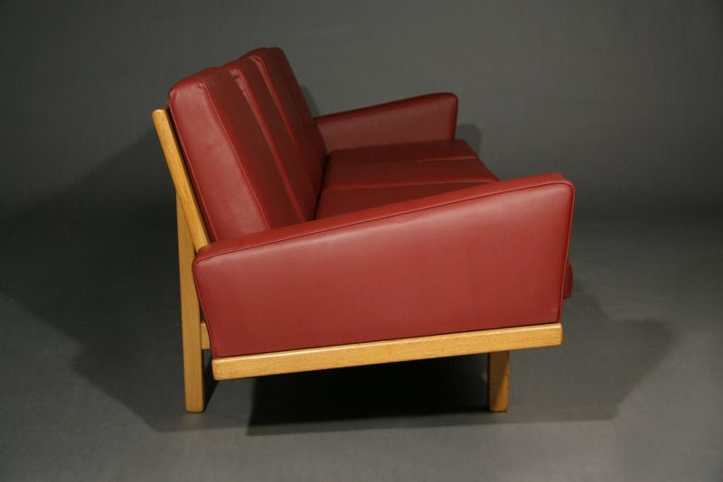 Danish Oak frame sofa with red leather upholstery 