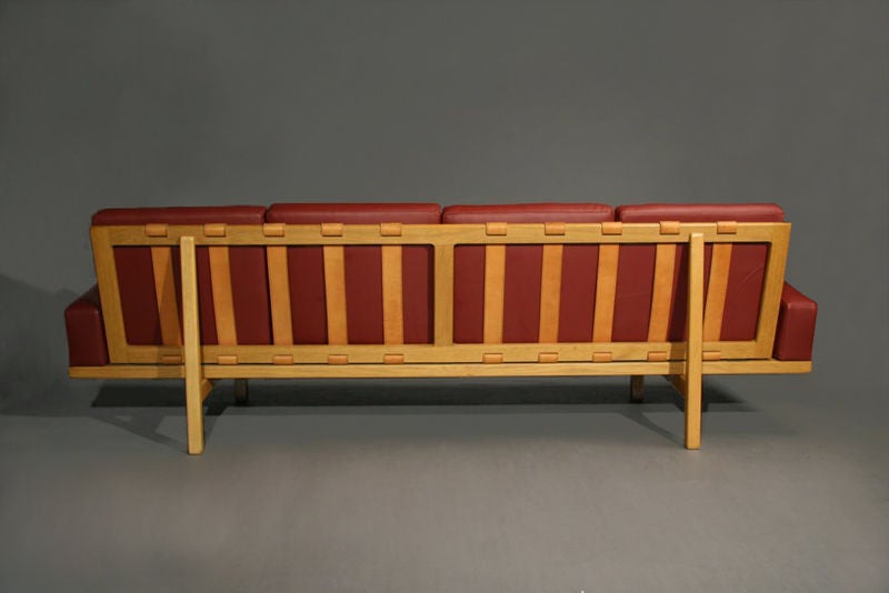 Oak frame sofa with red leather upholstery  1