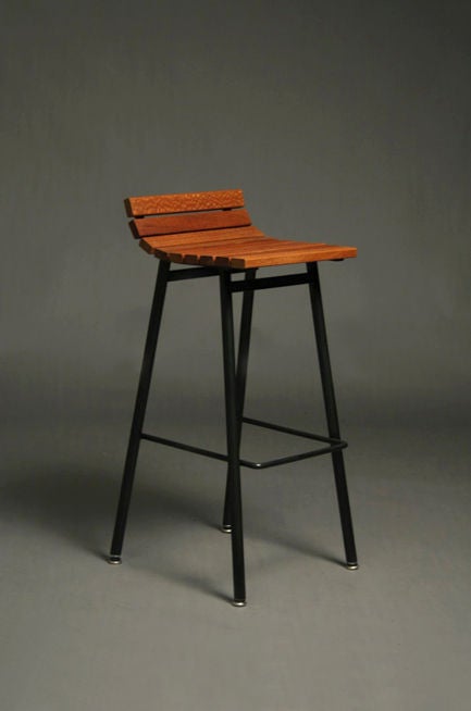 Custom slat wood and black powder coated iron bar stools designed by Thomas Hayes. Stools are available in four different woods (pictured left to right): purpleheart, ipe, zebrawood, and lacewood. Base is shown as black but is available in other