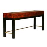 A rosewood console table with flip top and brass stretchers