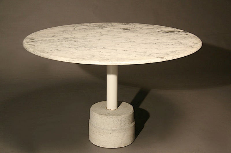 A round marble dining table with cement base
