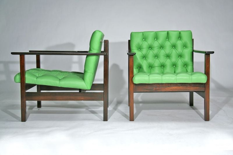 Pair of rosewood arm chairs upholstered in lime green micro tufted leather. Solid rosewood has been sealed and hand oiled to produce a natural wood finish.