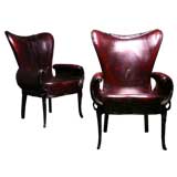 A pair of Gothic arm chairs with waxed red black leather