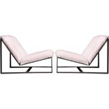Pair of bronze frame lounge chairs with white hair on hide