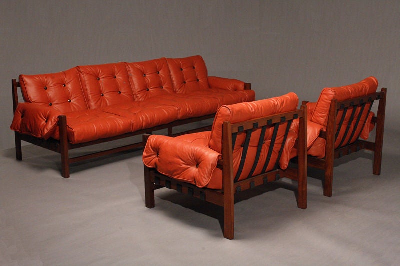 A rosewood and red leather sofa with black pigskin straps 3