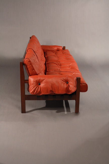 Mid-20th Century A rosewood and red leather sofa with black pigskin straps
