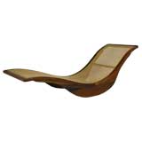 A rocking wood and caned chaise longue by Igor Rodrigues