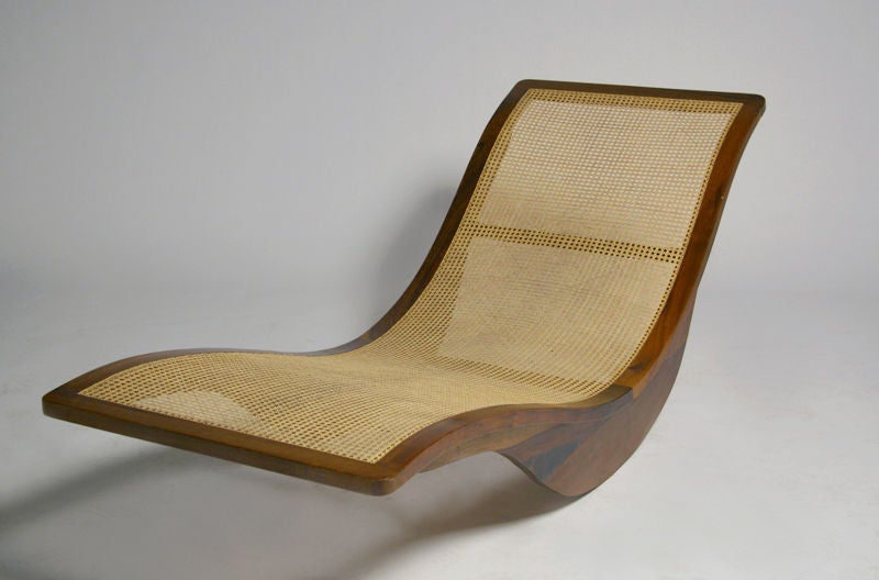 This Brazilian designer has designed a swooping rocking chaise longue composed of exotic hardwood with a caned support.<br />
<br />
Height at feet: 15.5