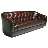Pair of curved tufted leather sofas by Ward Bennett