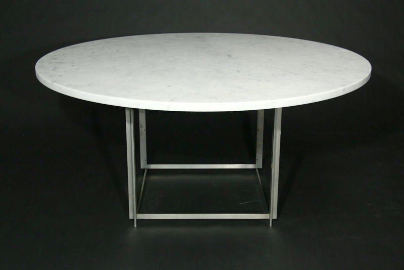 The PK 54 table was made for dining or conference use and is composed of six squares of matte chrome steel that a intermeshed to form a solid base for the white marble top. Stamped with E. Kold Christensen mark.<br />
<br />
Marble is 1 3/8