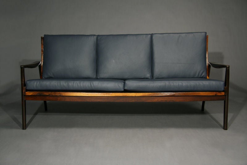 Blue leather cushions on a dark rosewood frame with a slat back and angled back legs from Brazil.