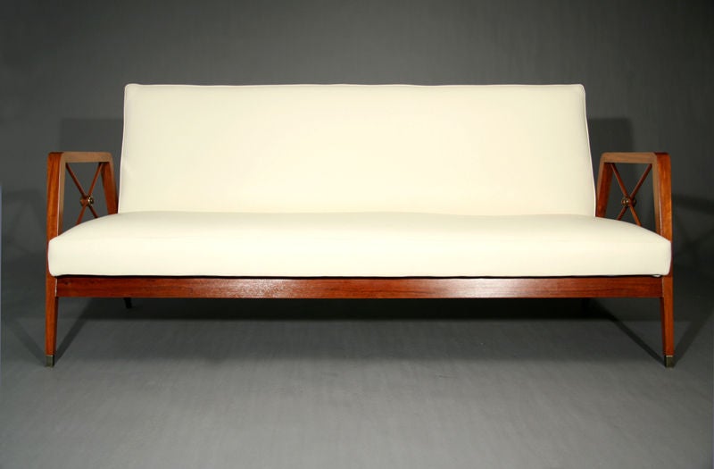 Cream leather and exotic wood frame sofa with bronze feet and medallions designed for Cavallaro, Brazil. See also separate listing with matching pair of chairs in dark brown leather.