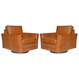 Pair of faux armadillo leather swivel arm chairs by Baker