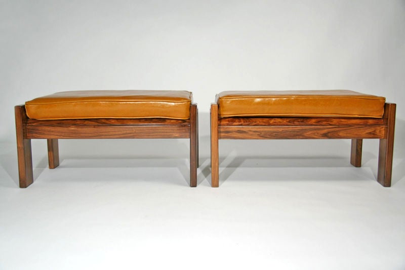 Pair of caviuna wood stools or ottomans with leather tops that flip up designed by Jorge Zalszupin for L'Atelier for the Hotel Nacional, designed by Oscar Niemeyer, in Rio de Janeiro. This particular pair has been sold but we have another identical