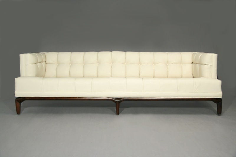 Attractive cream leather sofa with mahogany base designed for Monteverdi-Young.