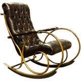 A leather and heavily patinated rocking chair