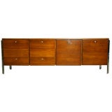 A teak and chrome leg cabinet with locking drawers