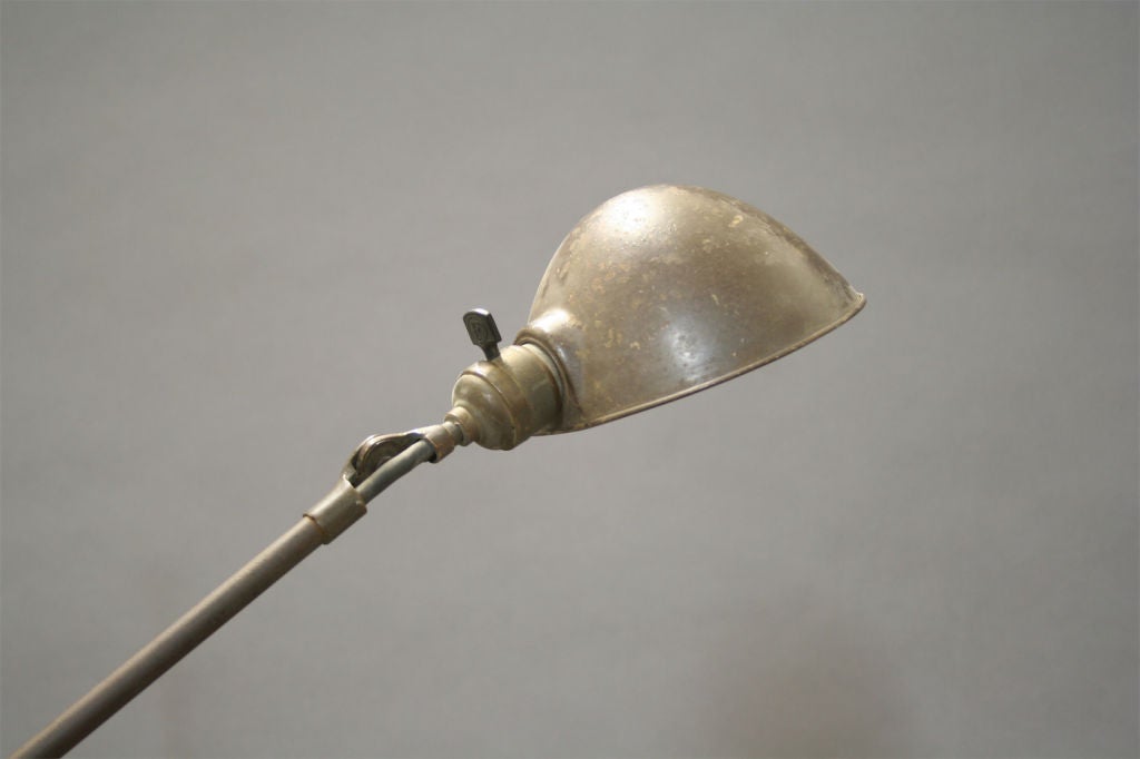 Two arm articulated brass telescoping floor lamp, with parabolic shade. Dimpled knuckle joint allows easy adjustment of both arms and shades.