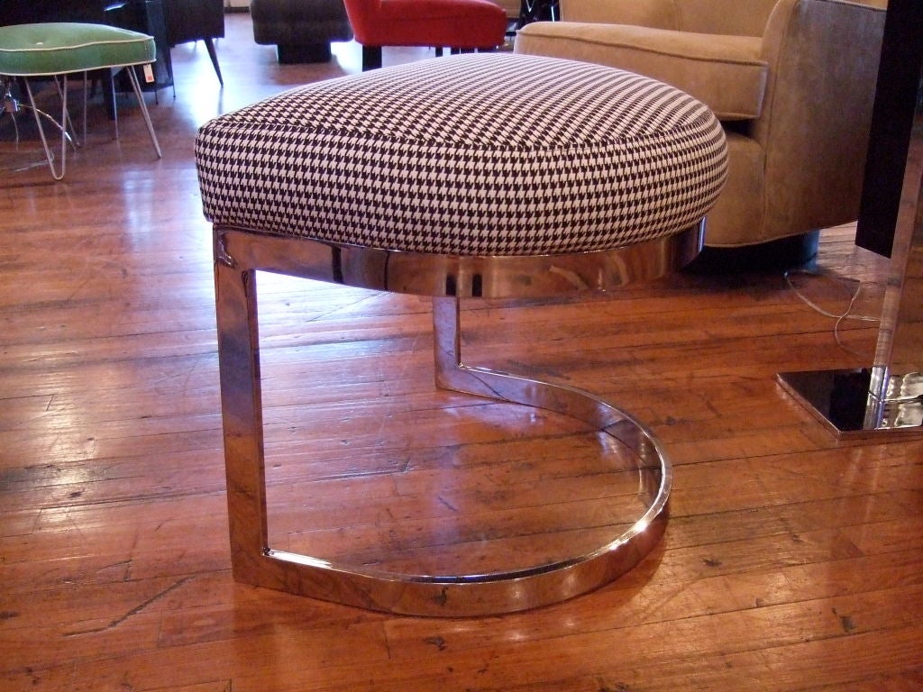 The Houndstooth Stool is a great addition to any room.  Semi circular chrome stool in the manner of milo baughman newly polished and upholstered in a cotton houndstooth pattern.  Create the ultimate spot for reading and relaxing in the living room