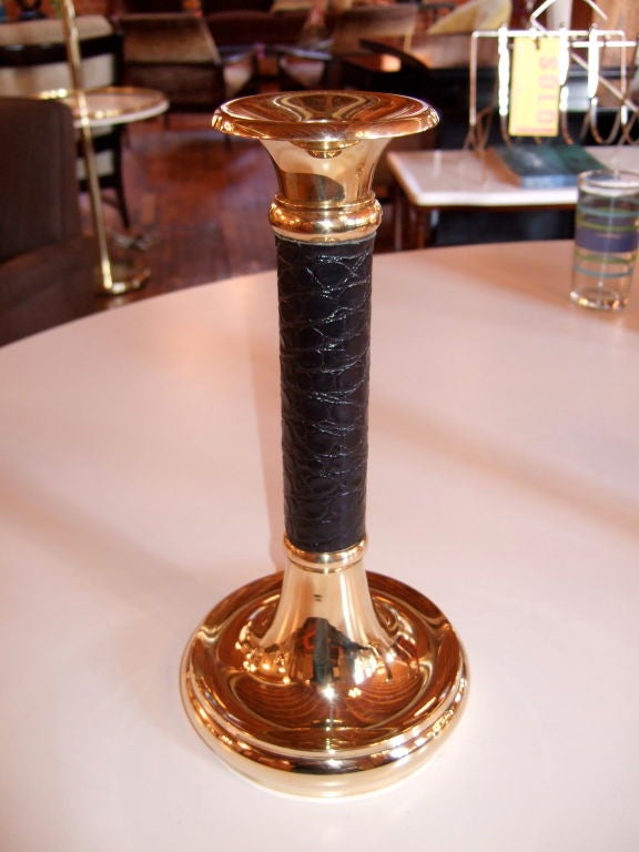 Pair of polished solid brass candlesticks with embossed black leather stems, newly sewn on.
